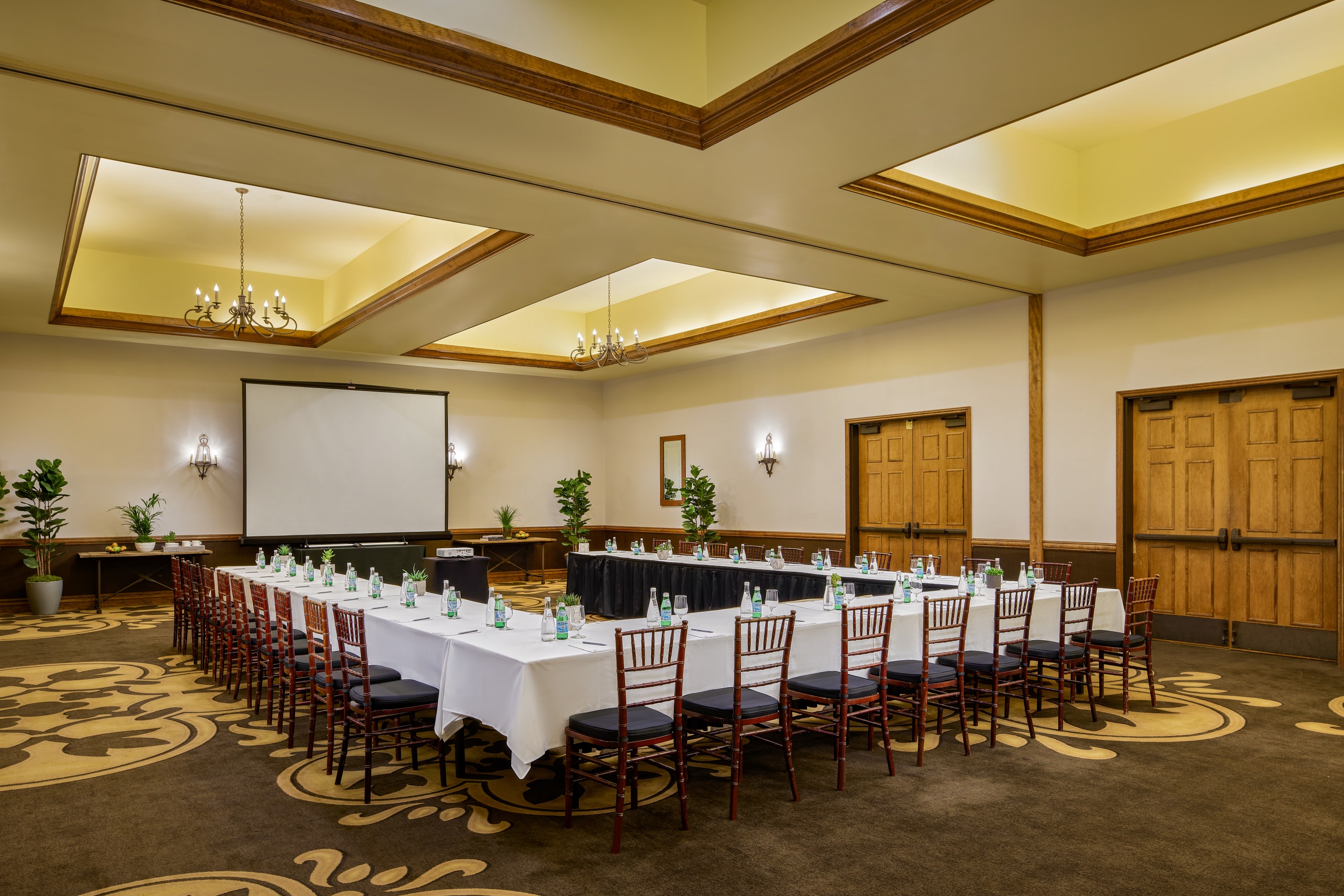 a room with a large table set for a meeting