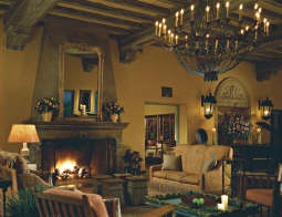 a living room with a chandelier and fireplace