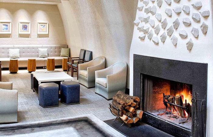 a room with a fireplace and chairs