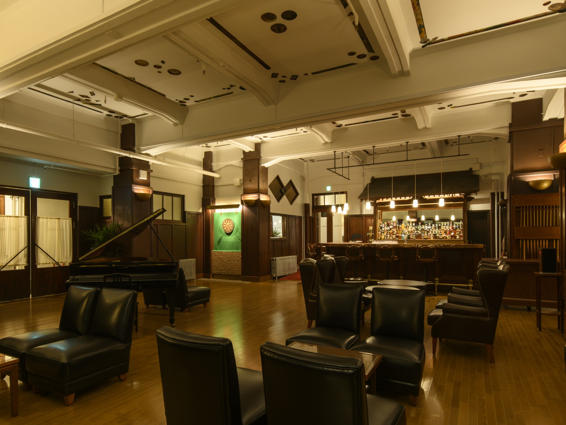 a room with a bar and chairs