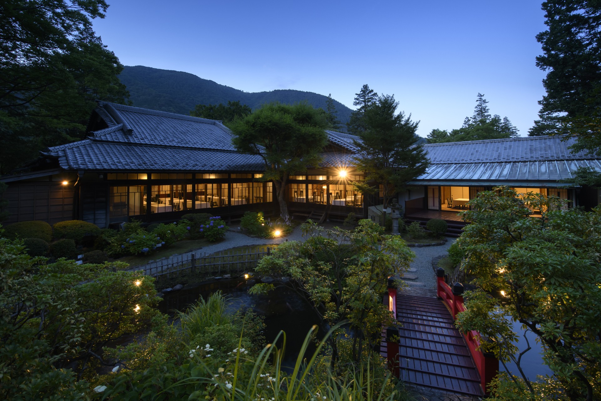 a building with trees and a pond