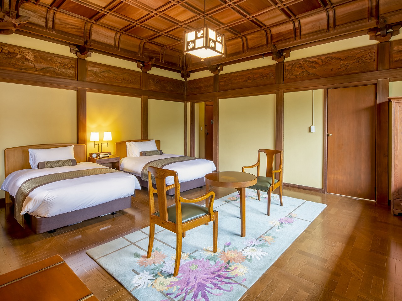a room with two beds and a table