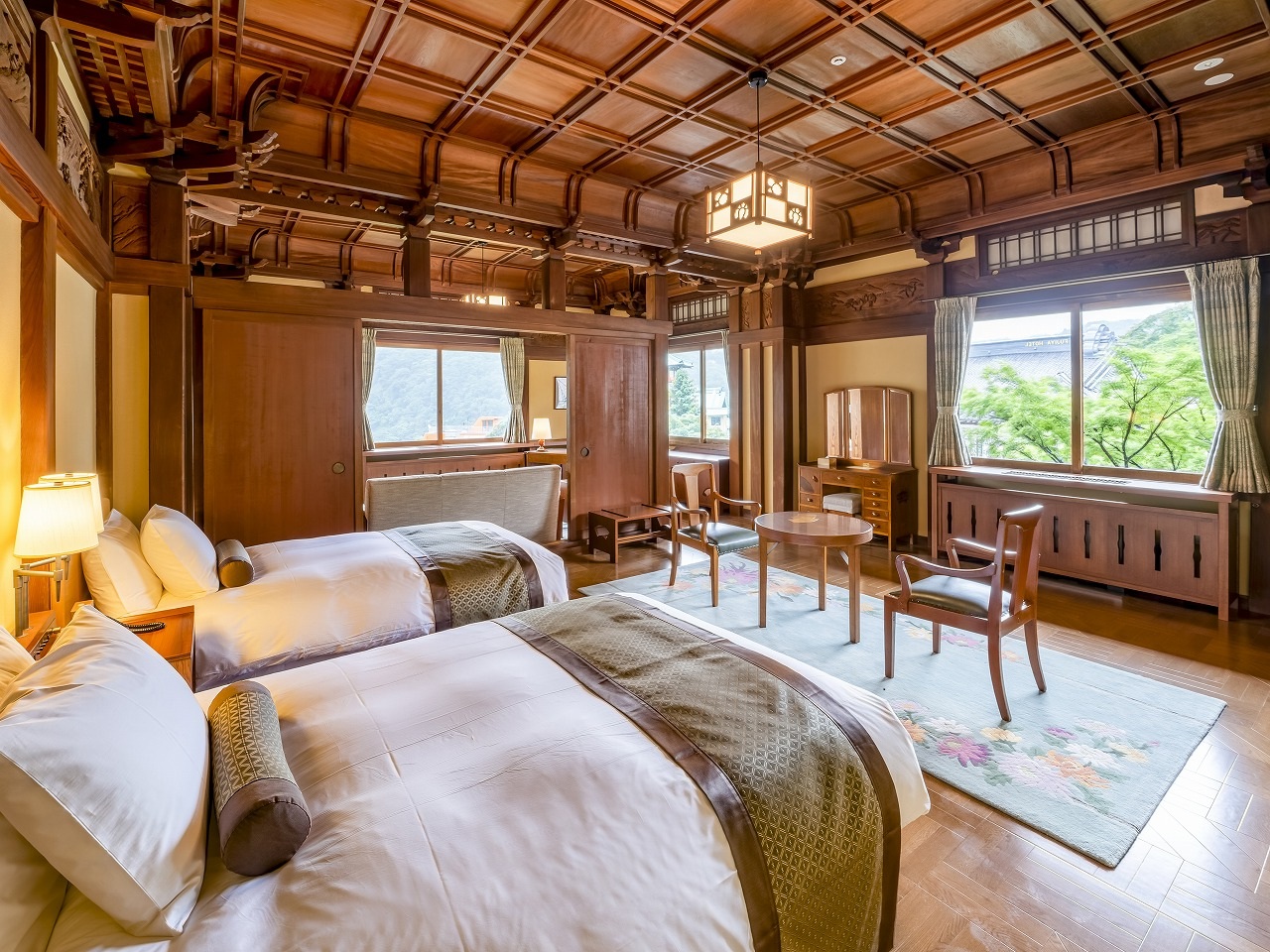 a room with two beds and a wood ceiling