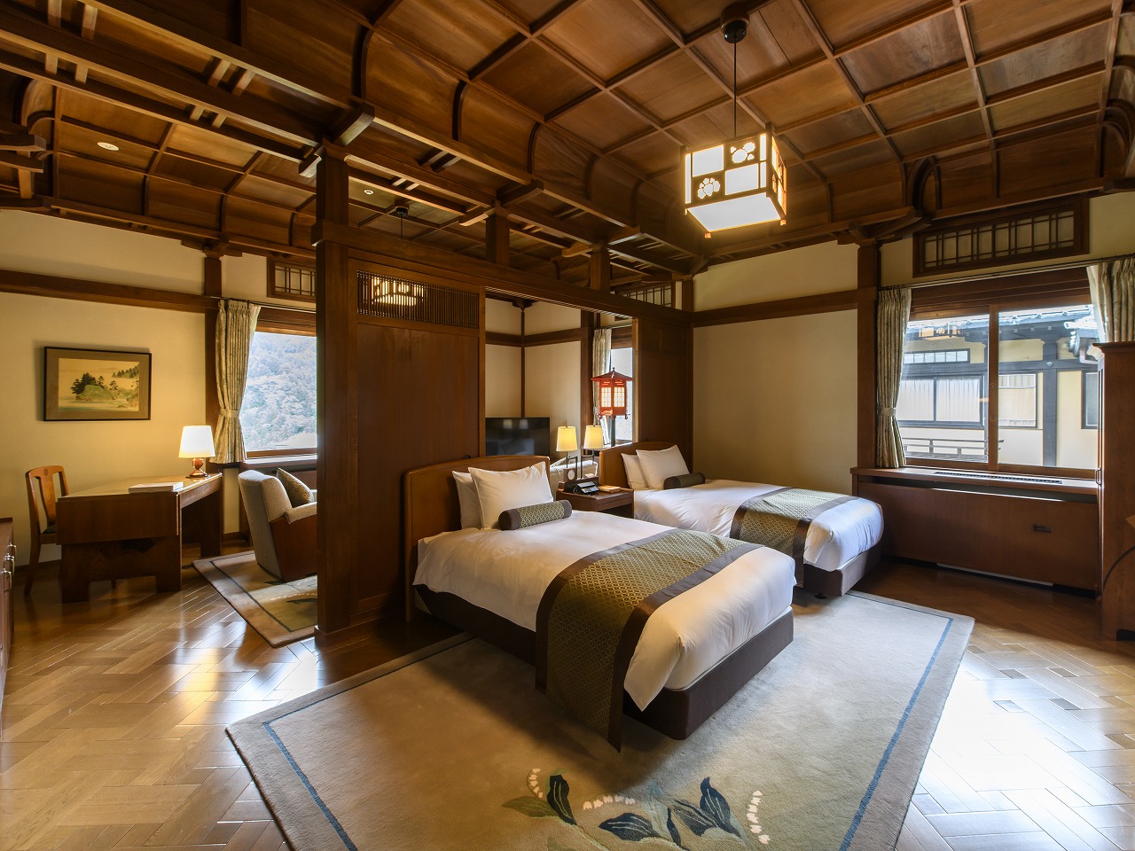 a room with two beds and a lamp