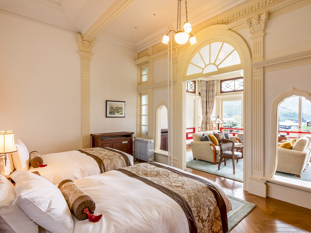 a room with two beds and a large window