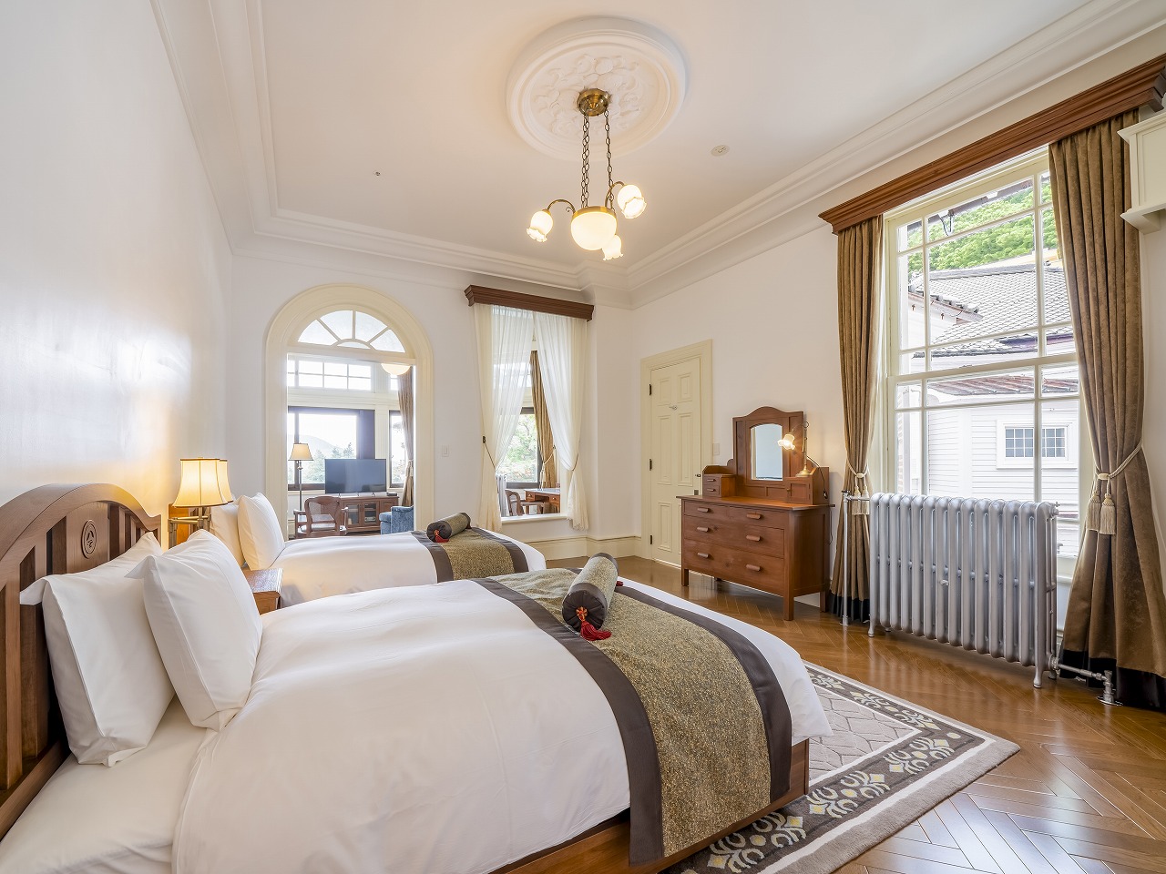 a room with two beds and a mirror