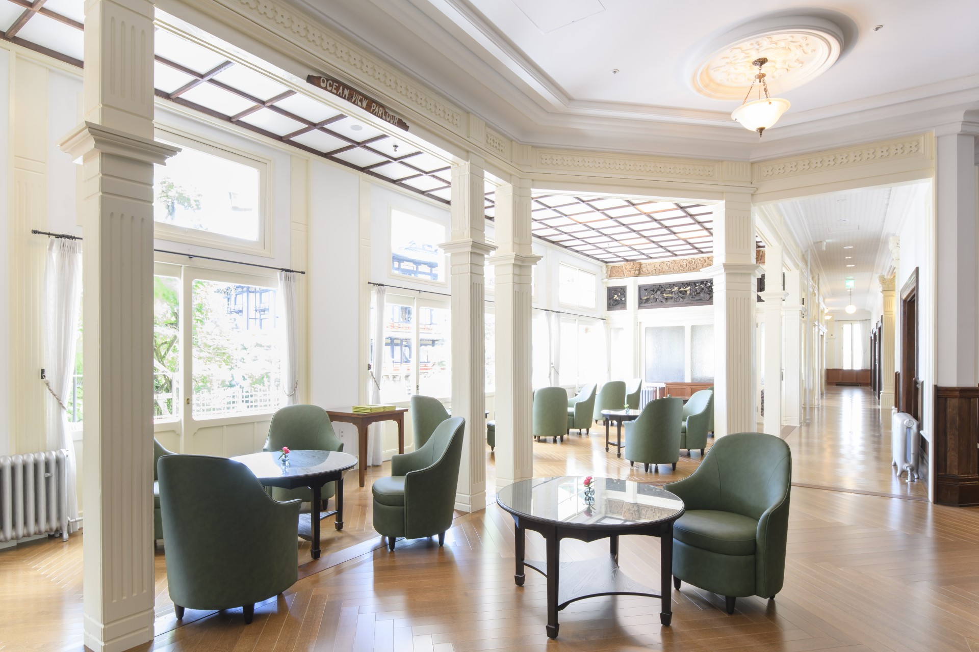 a room with green chairs and tables