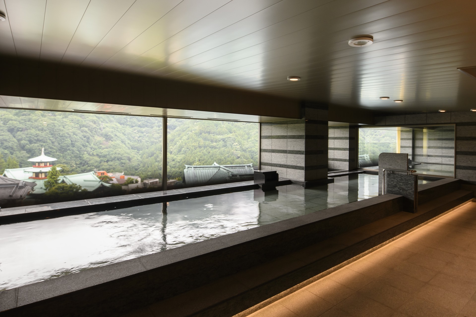 a large indoor pool with a large window