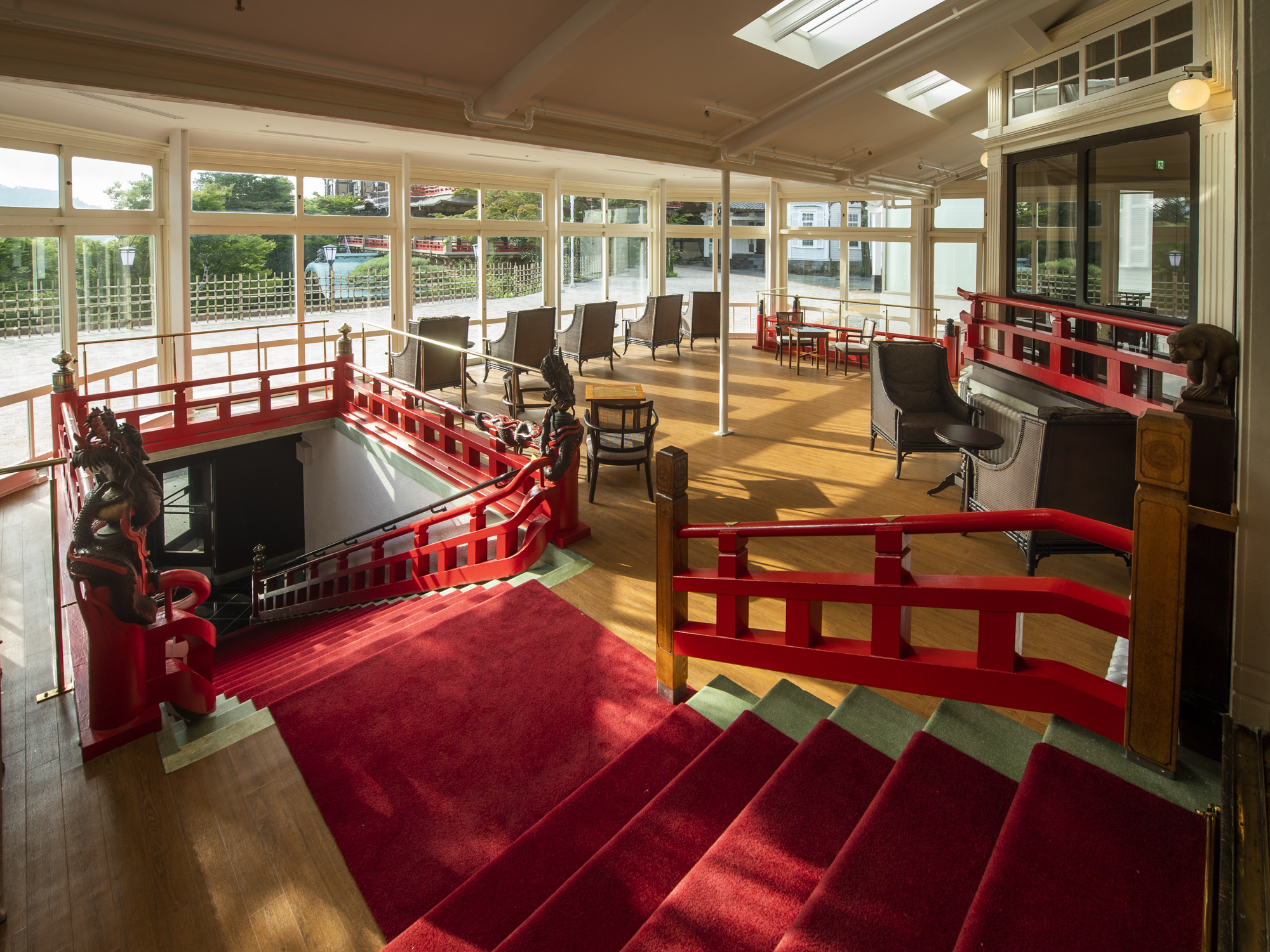 a room with red stairs and red railings