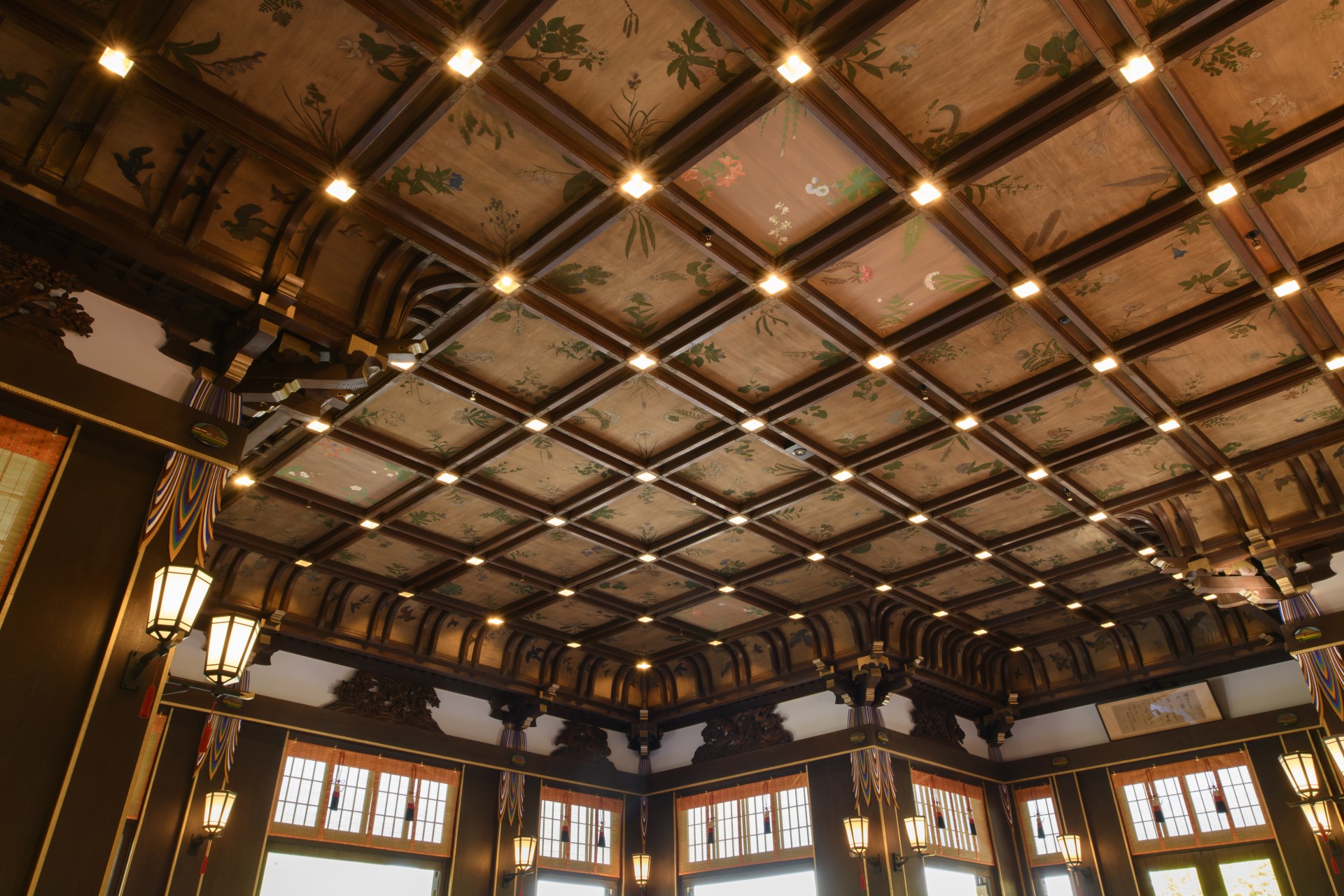 a ceiling with lights and a painting on the ceiling
