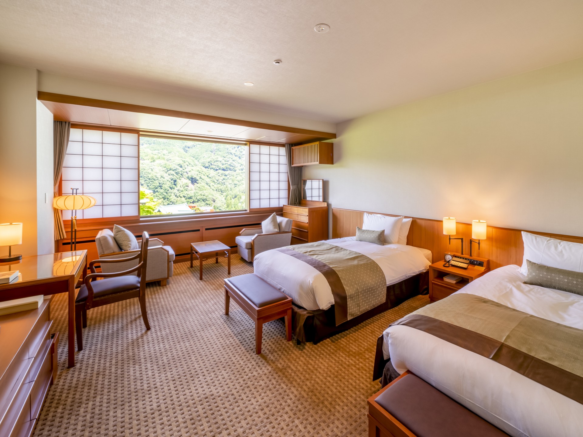 a room with two beds and a desk