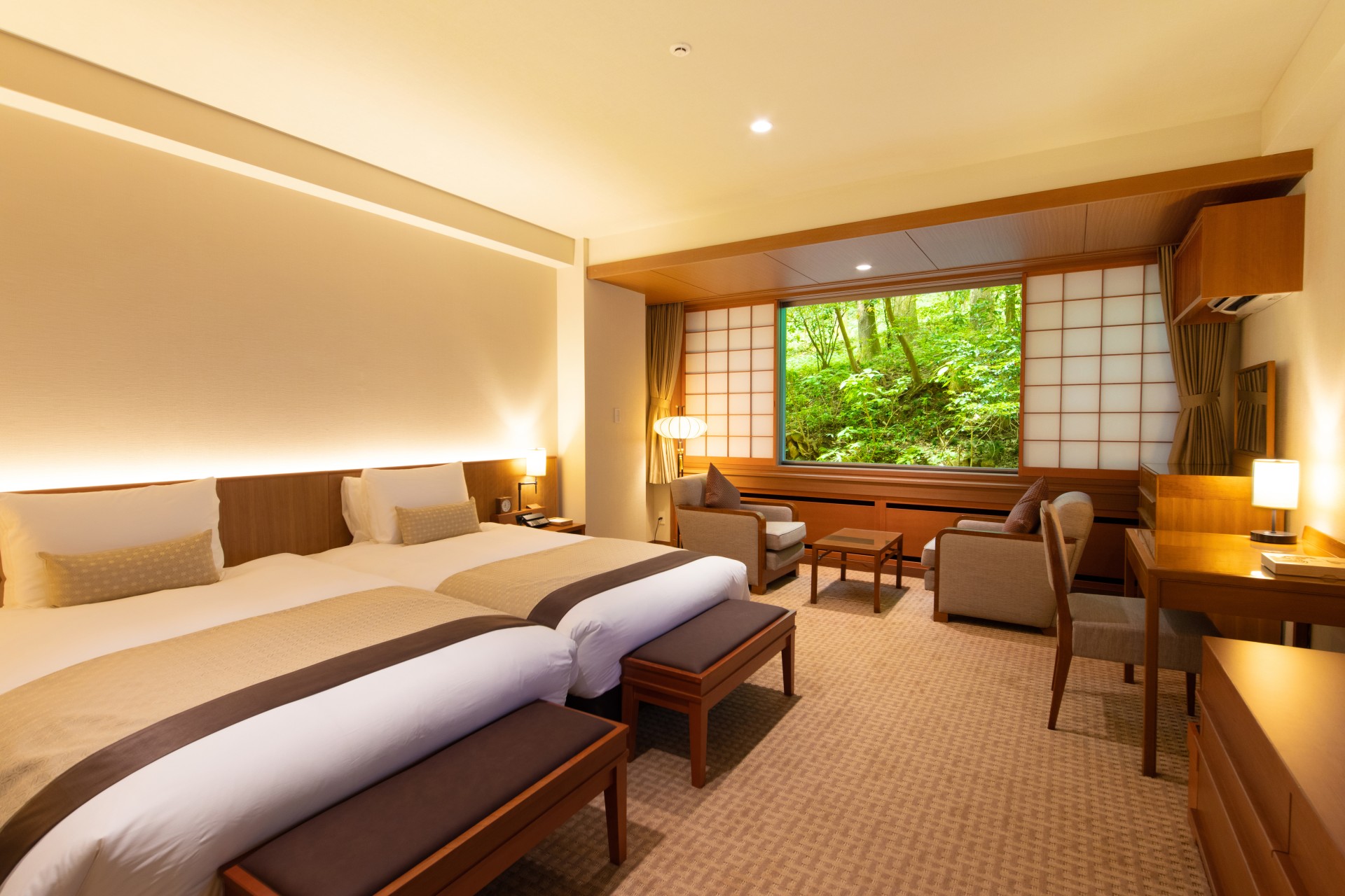 a room with a bed and chairs