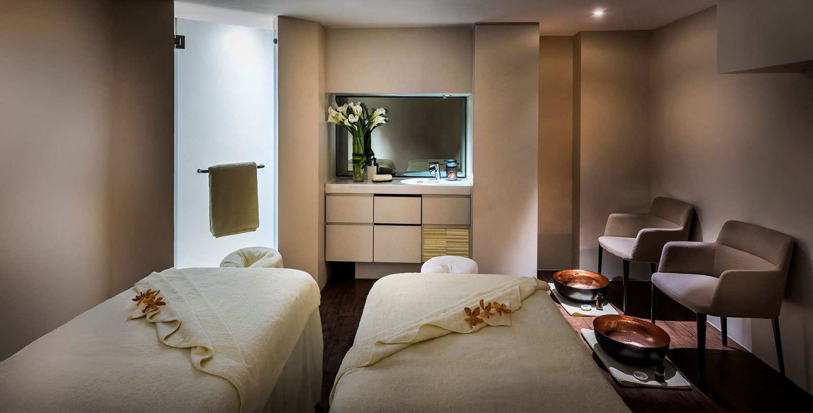 a room with two beds and a mirror