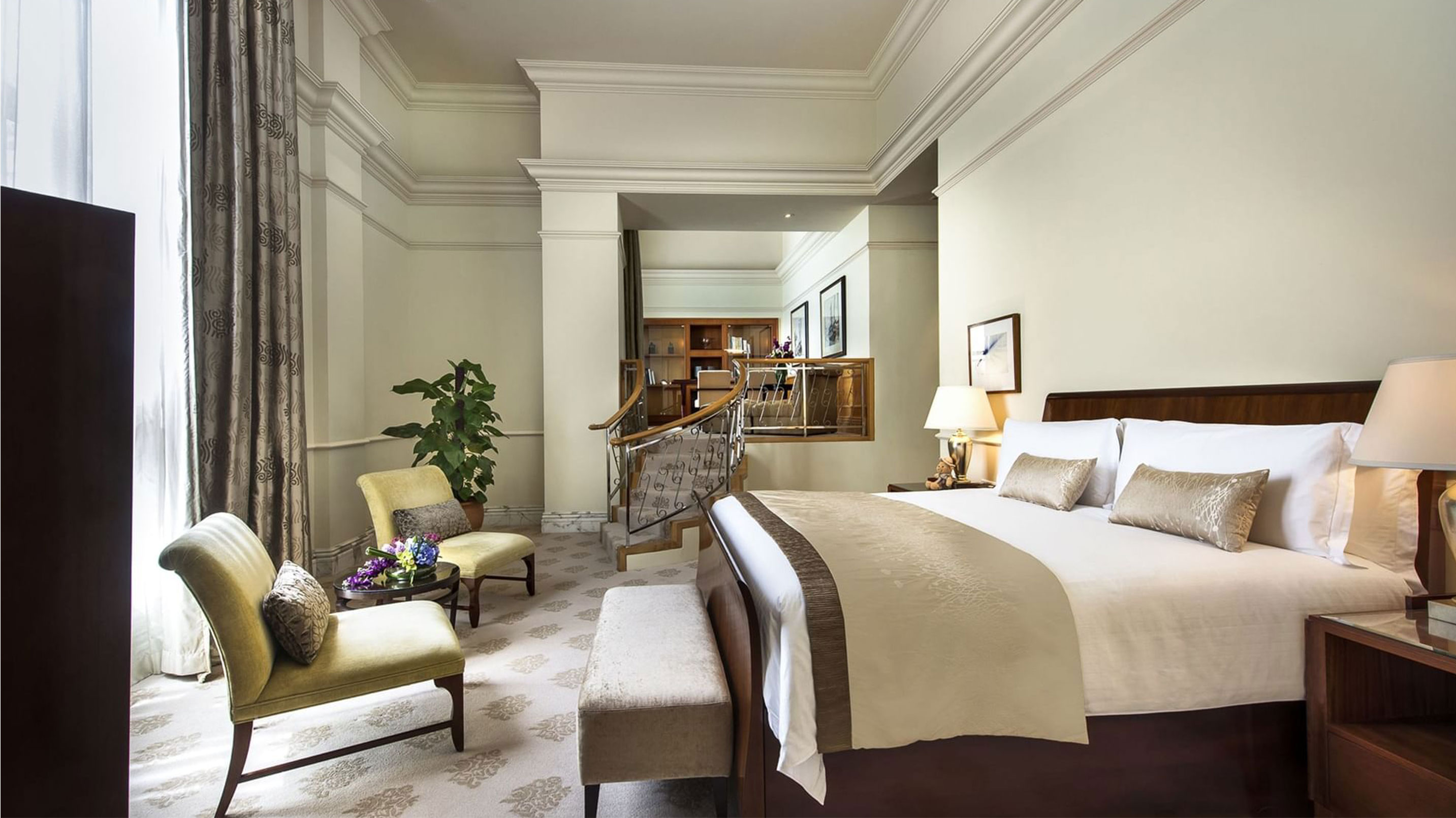 a bedroom with a bed and chairs