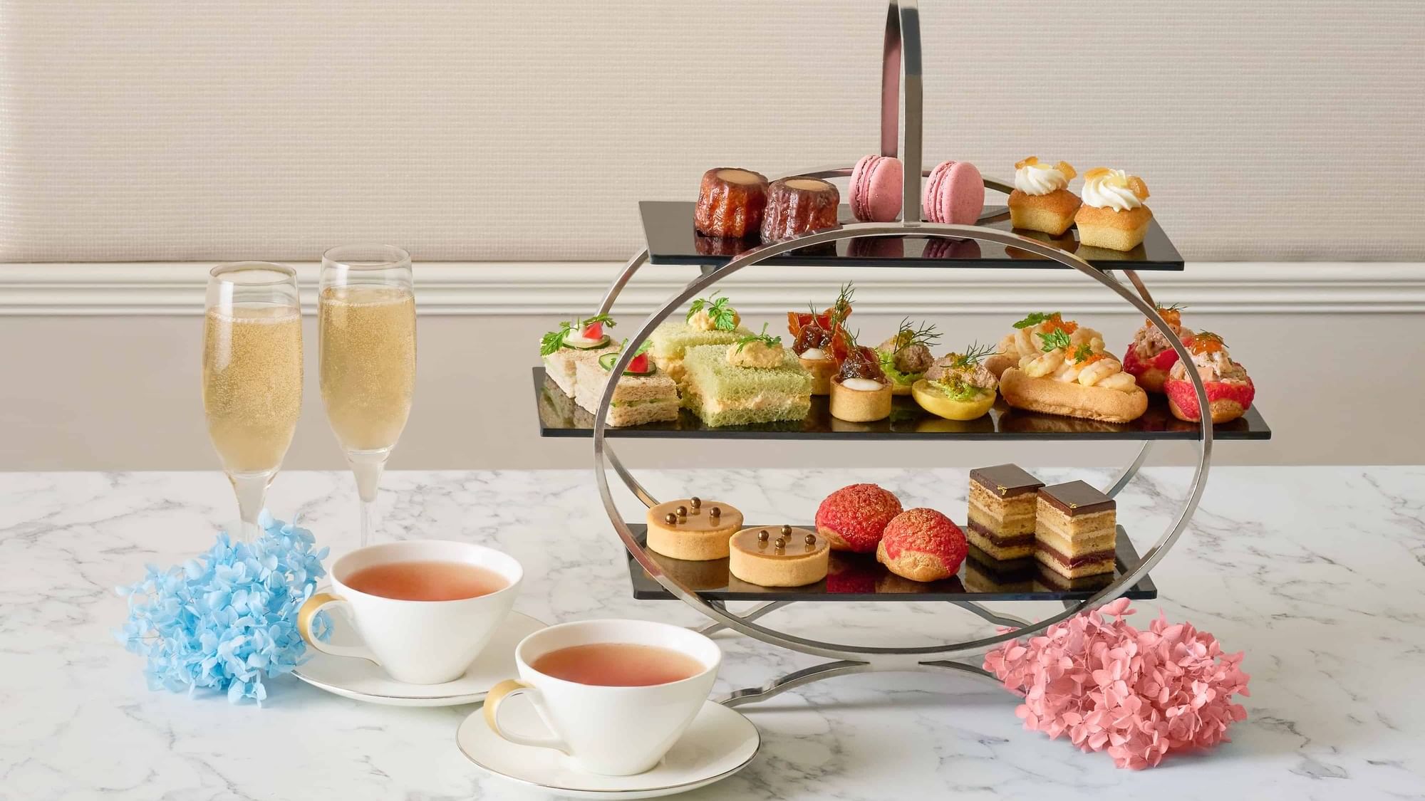 a tray of pastries and cups of tea