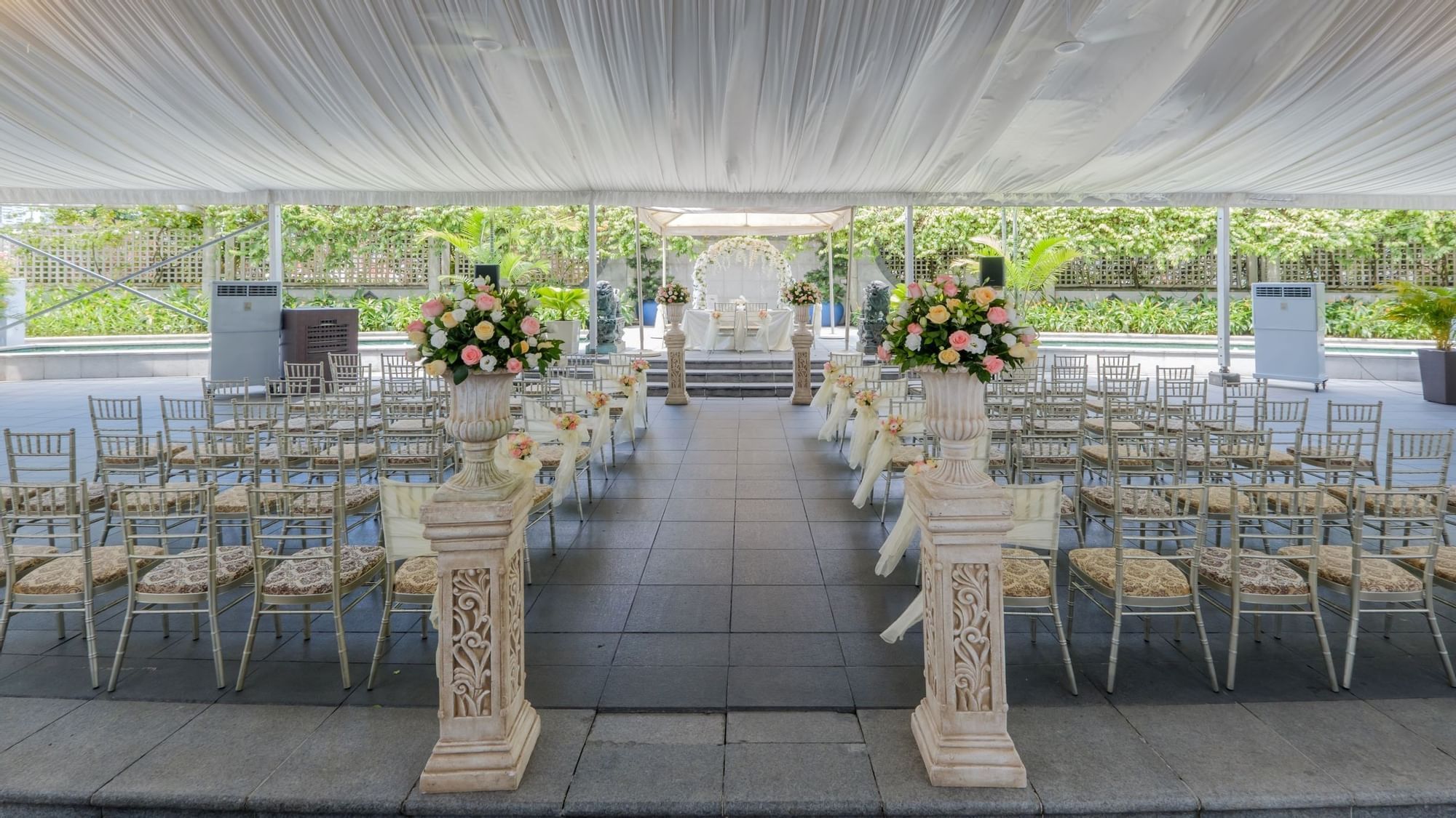 a wedding ceremony with chairs and flowers