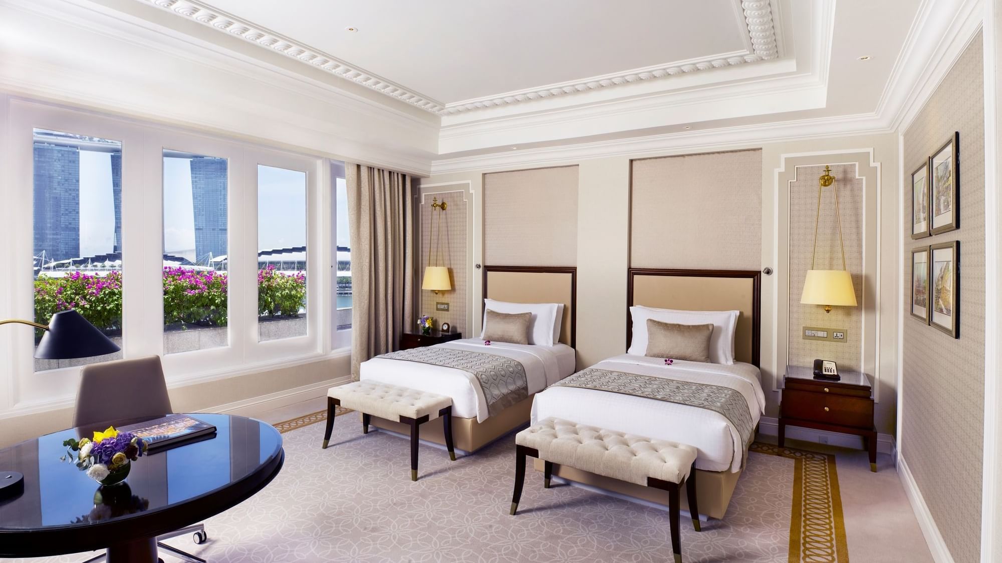 a room with two beds and a table
