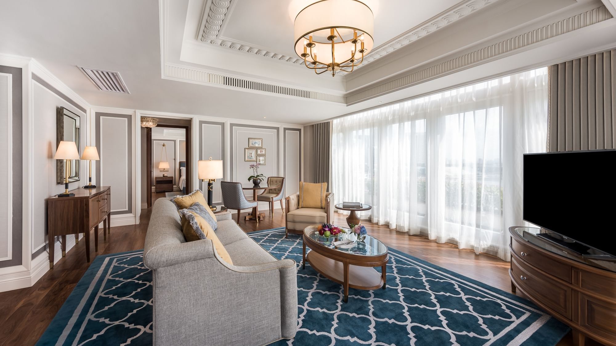 a living room with a chandelier and couches