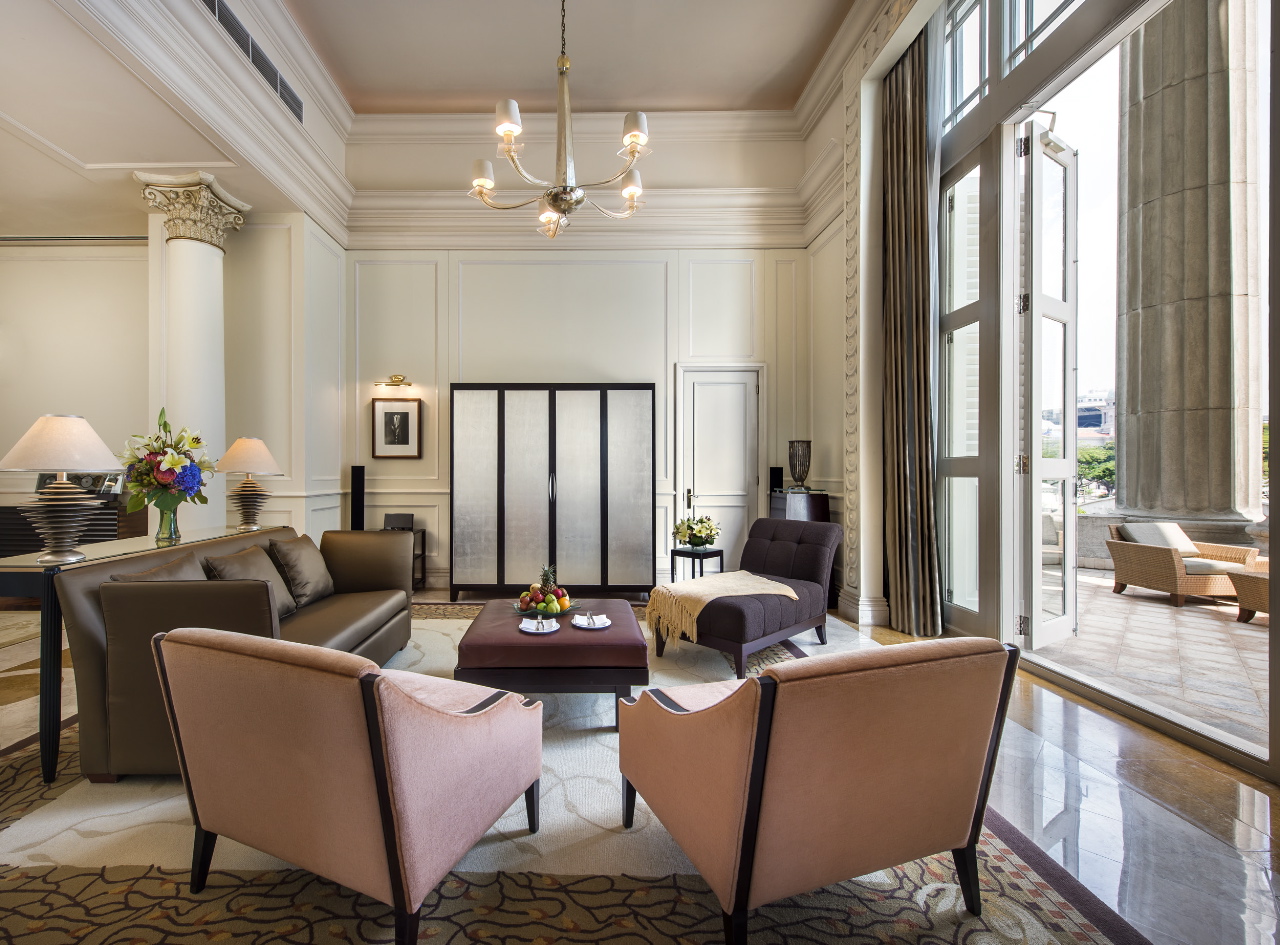 a living room with a chandelier and chairs