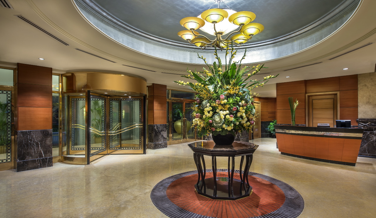 a large vase of flowers in a lobby