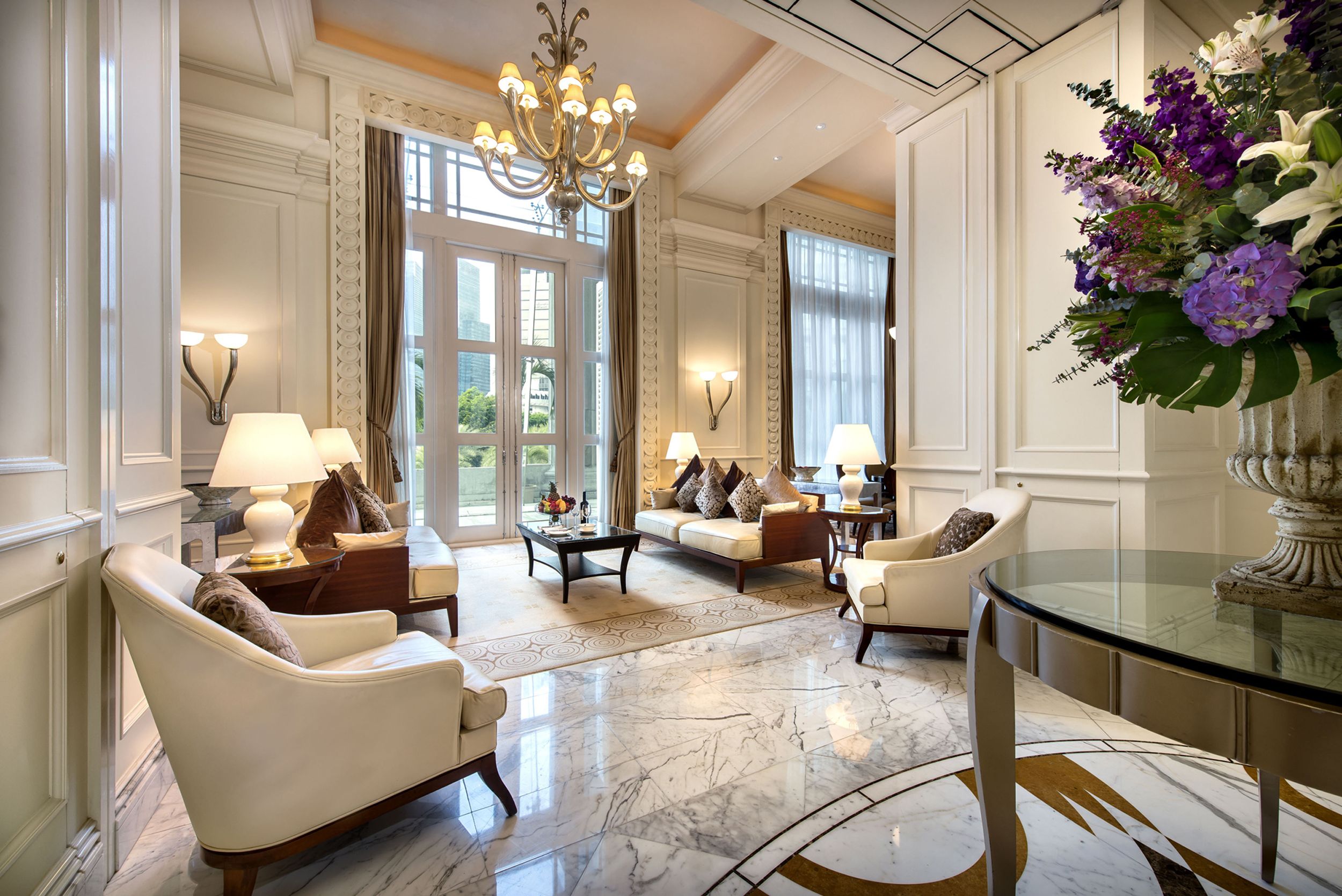 a room with white furniture and a chandelier