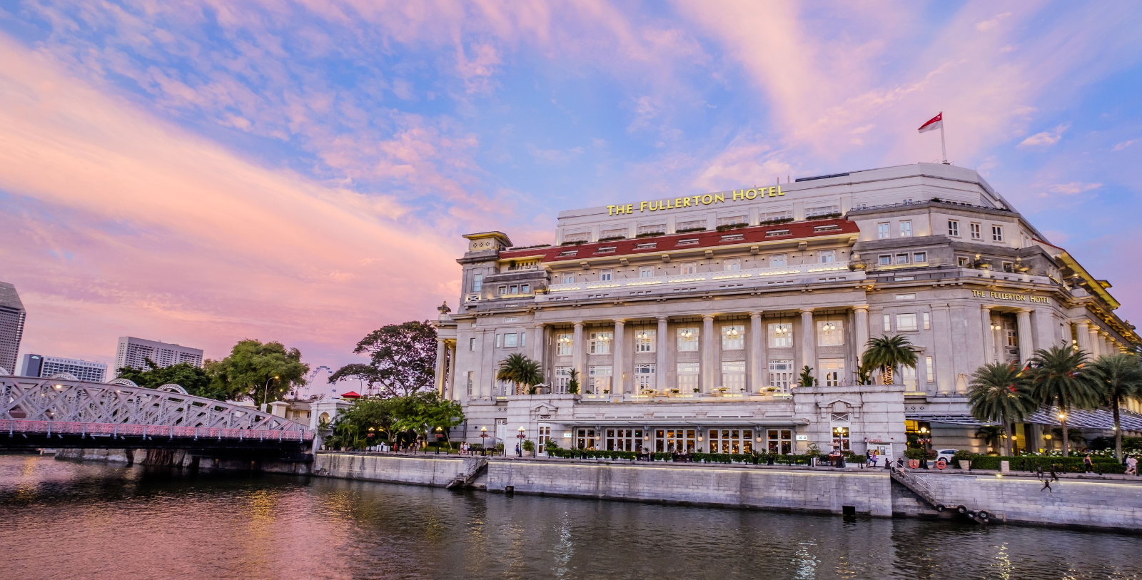 a large building with a river in the background