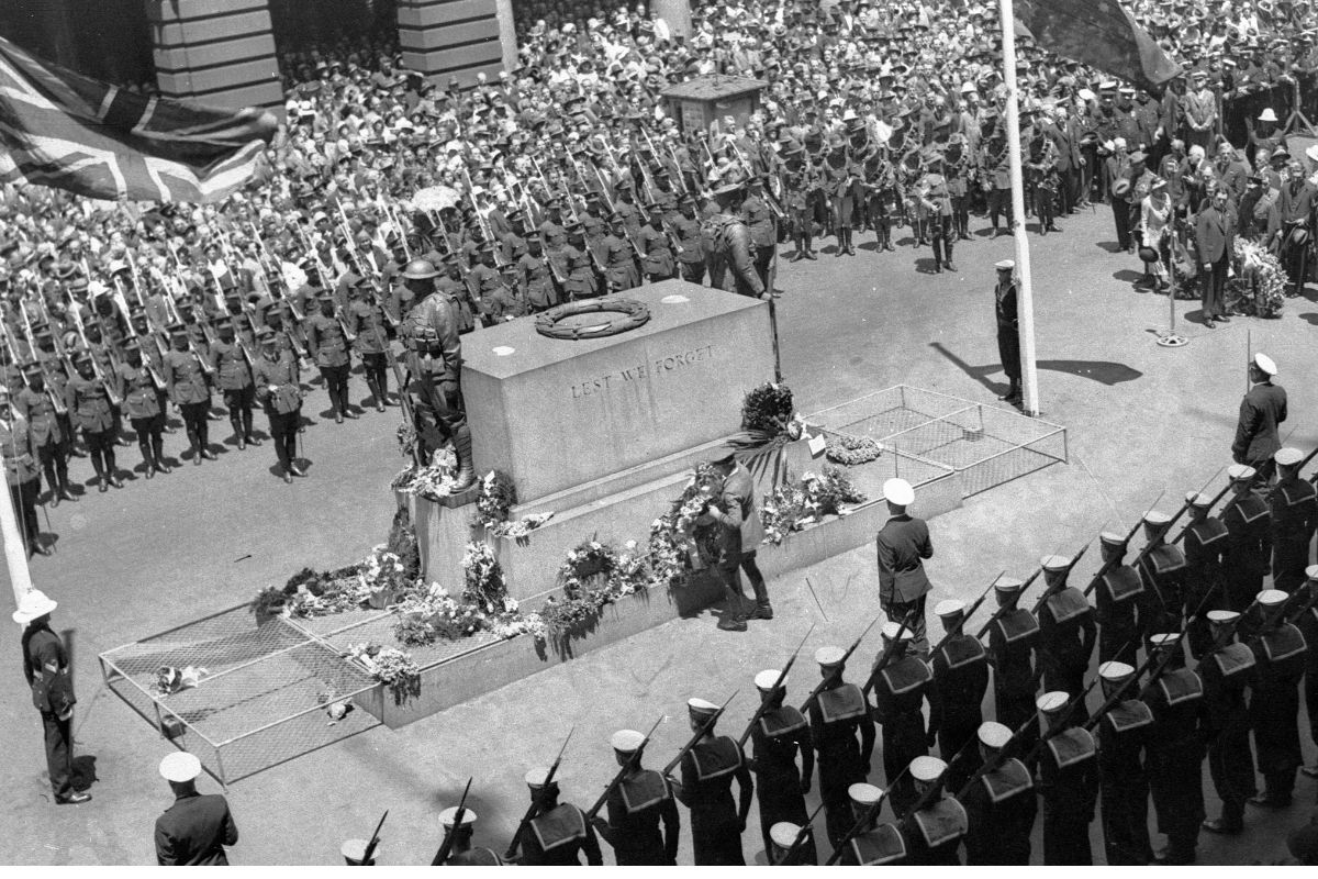 a group of people in uniform standing around a monument