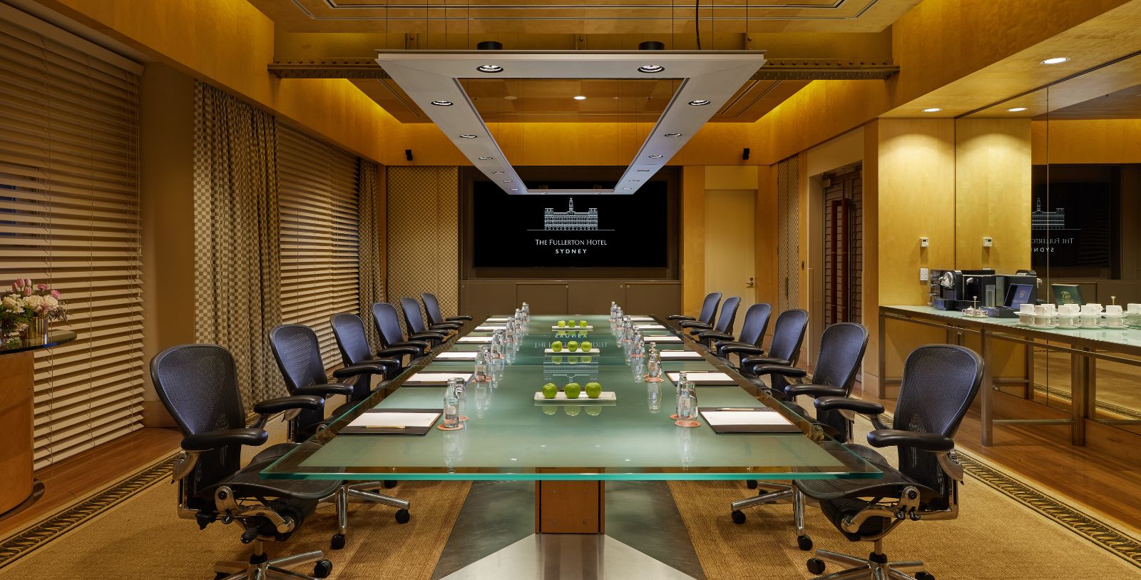 a conference room with a glass table and chairs