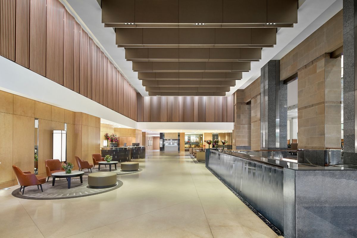 a lobby with a large counter and chairs