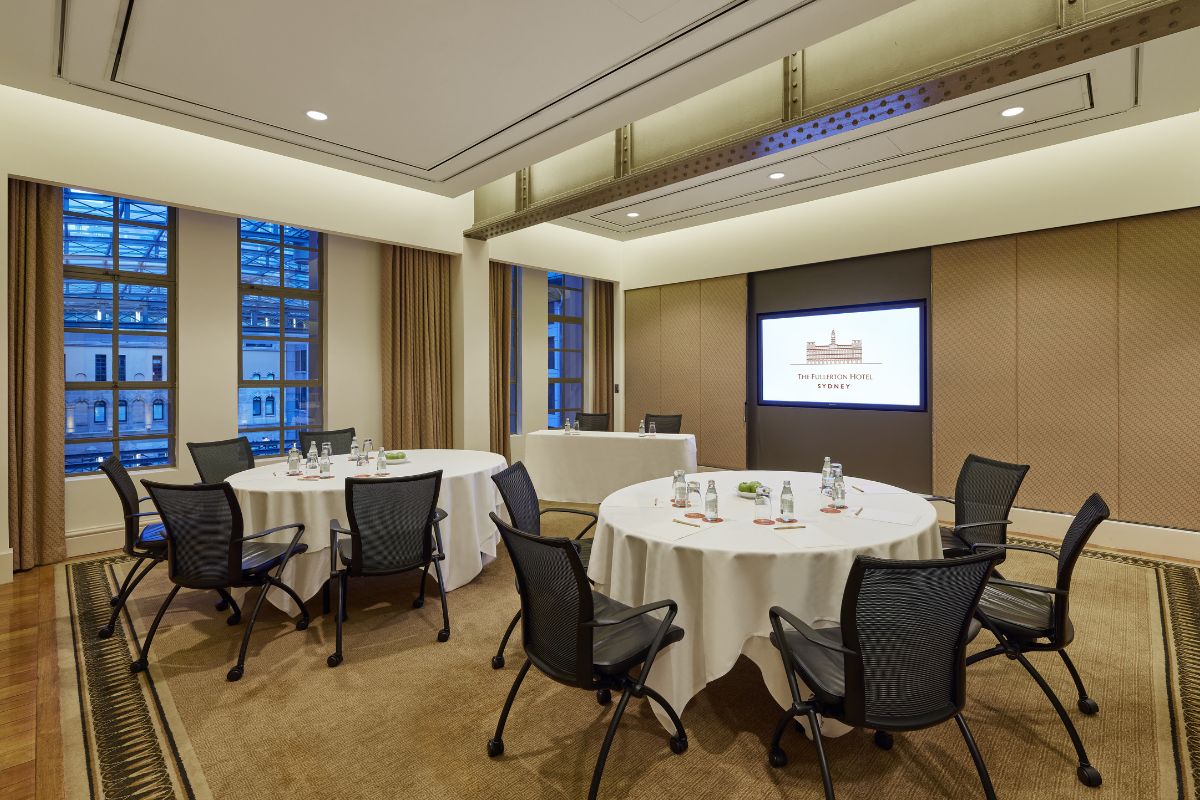 a room with round tables and chairs