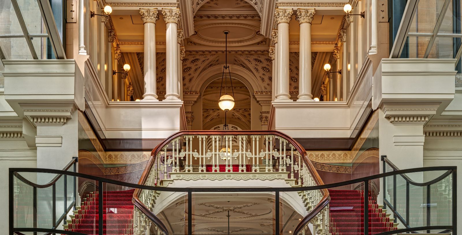 a staircase with a railing and a glass railing