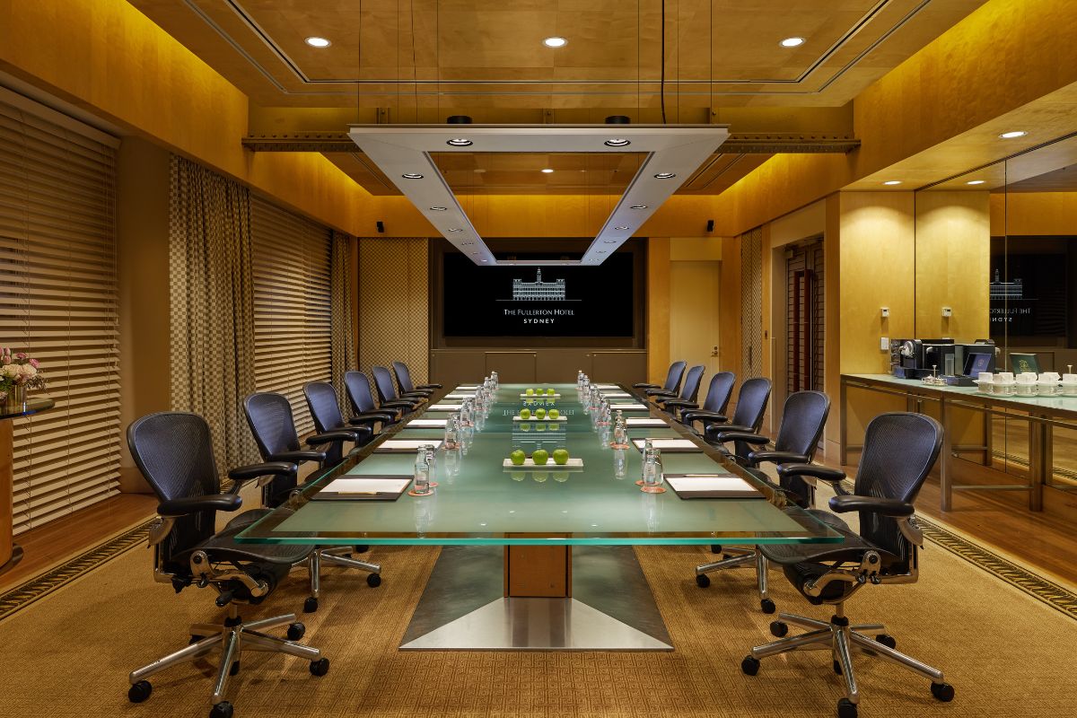 a conference room with a glass table and chairs