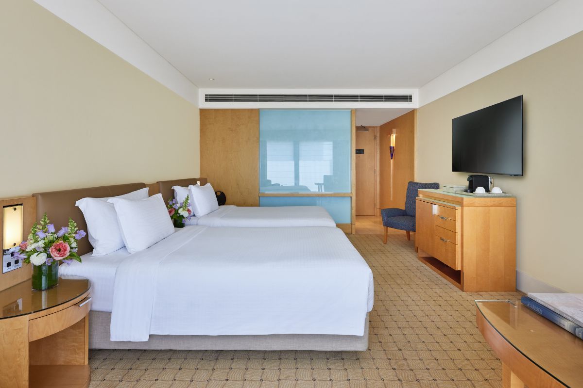 a room with two beds and a television