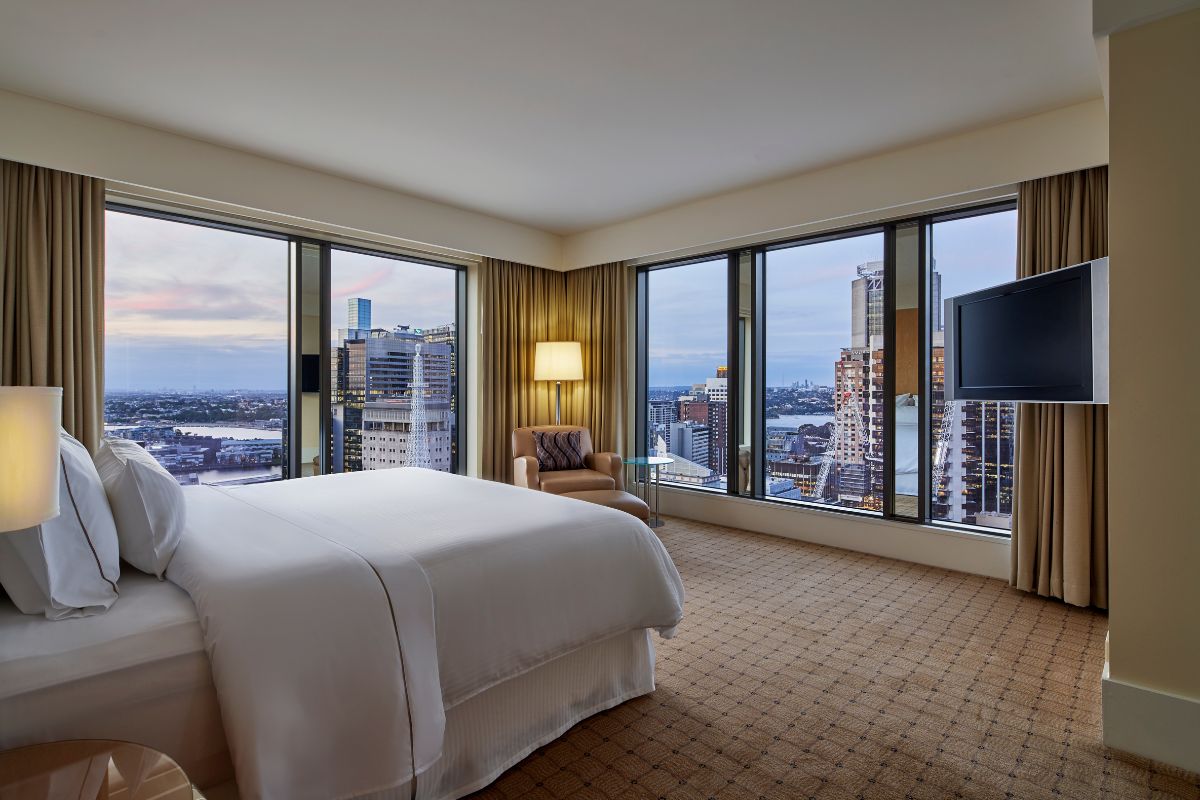 a room with large windows and a bed