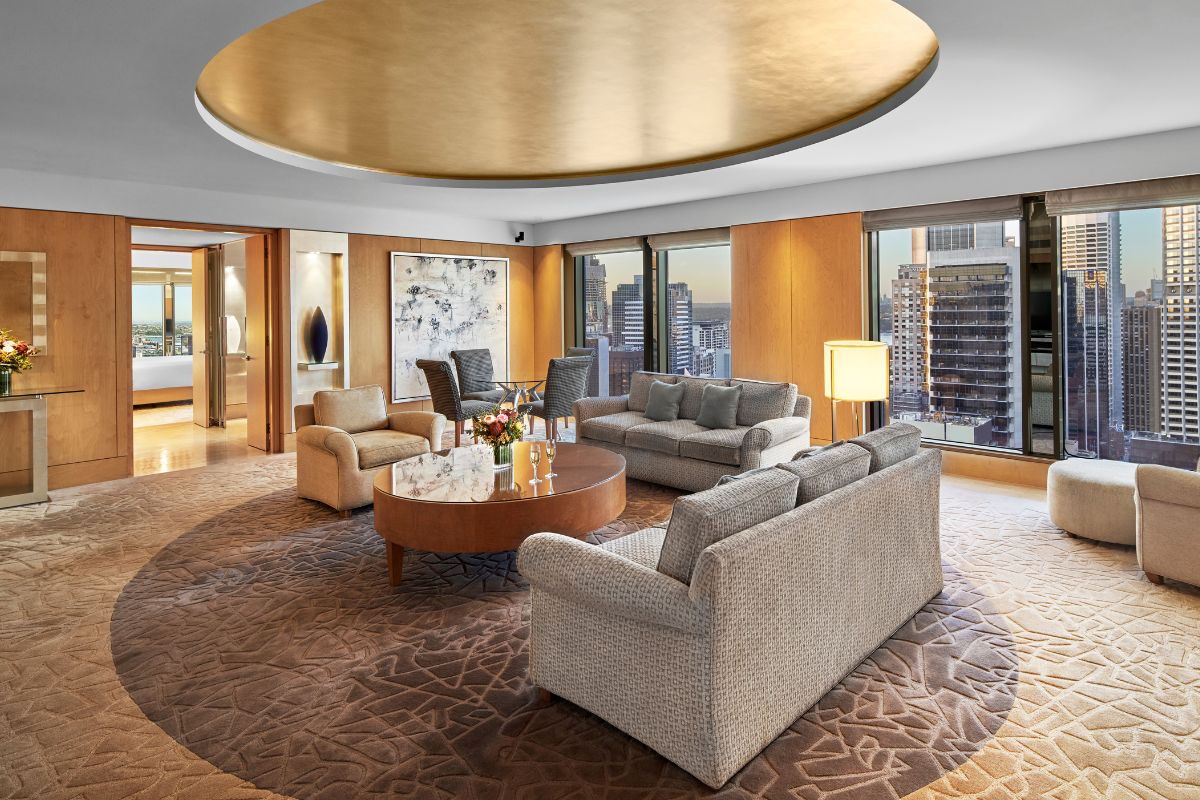 a room with a large round table and couches
