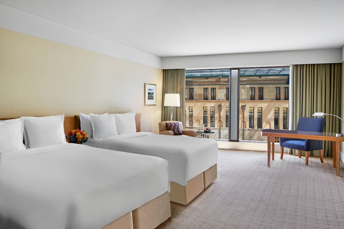 a hotel room with two beds and a table