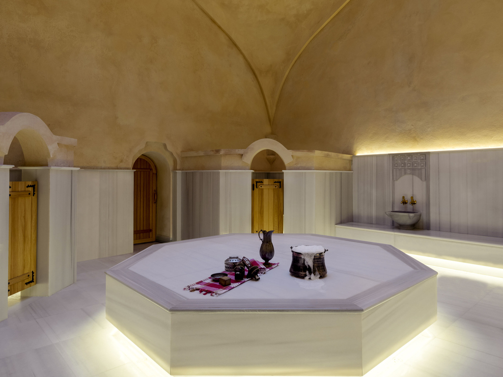 a room with a large white hexagon shaped room with a large white and brown ceiling
