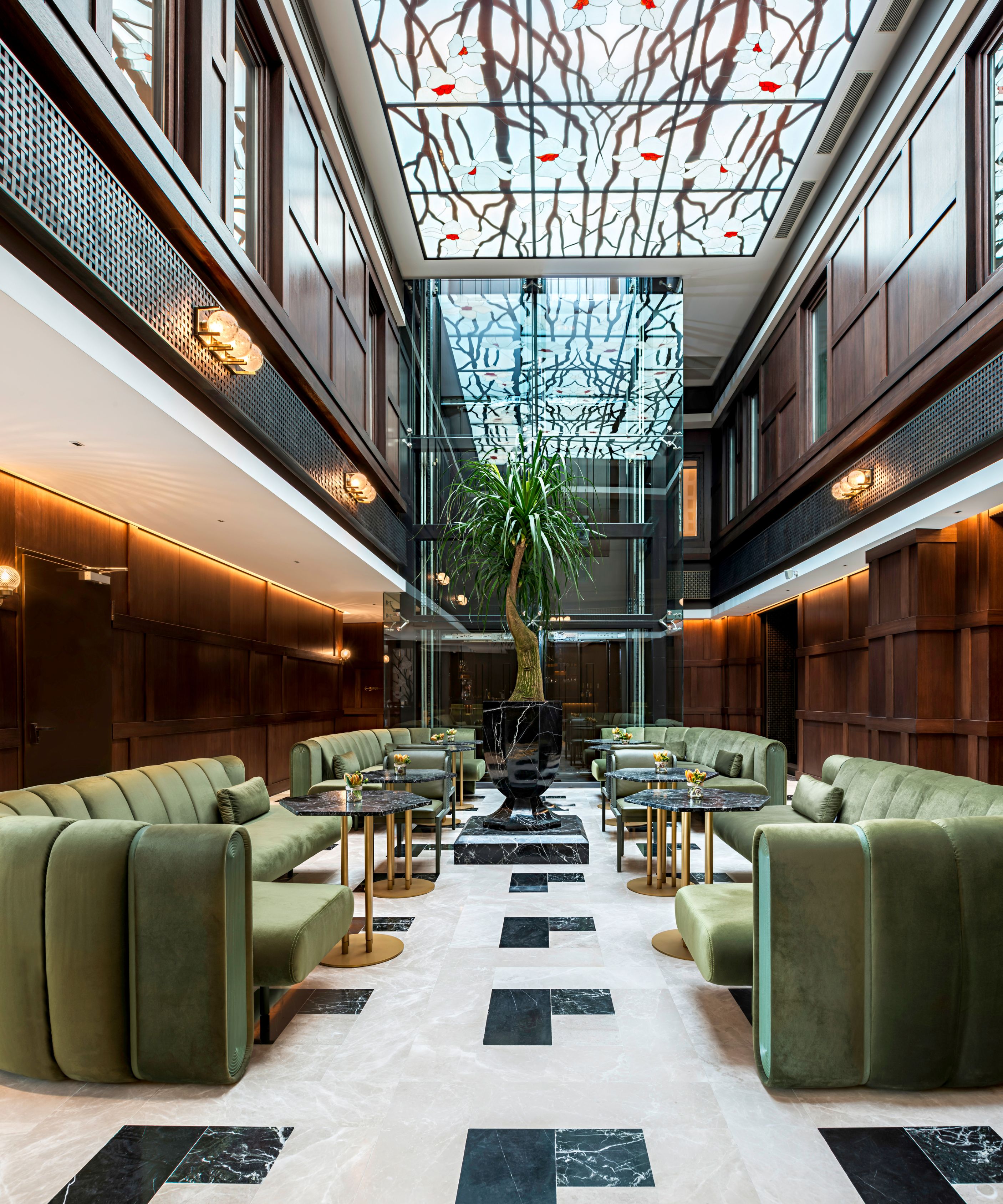 a room with green couches and tables