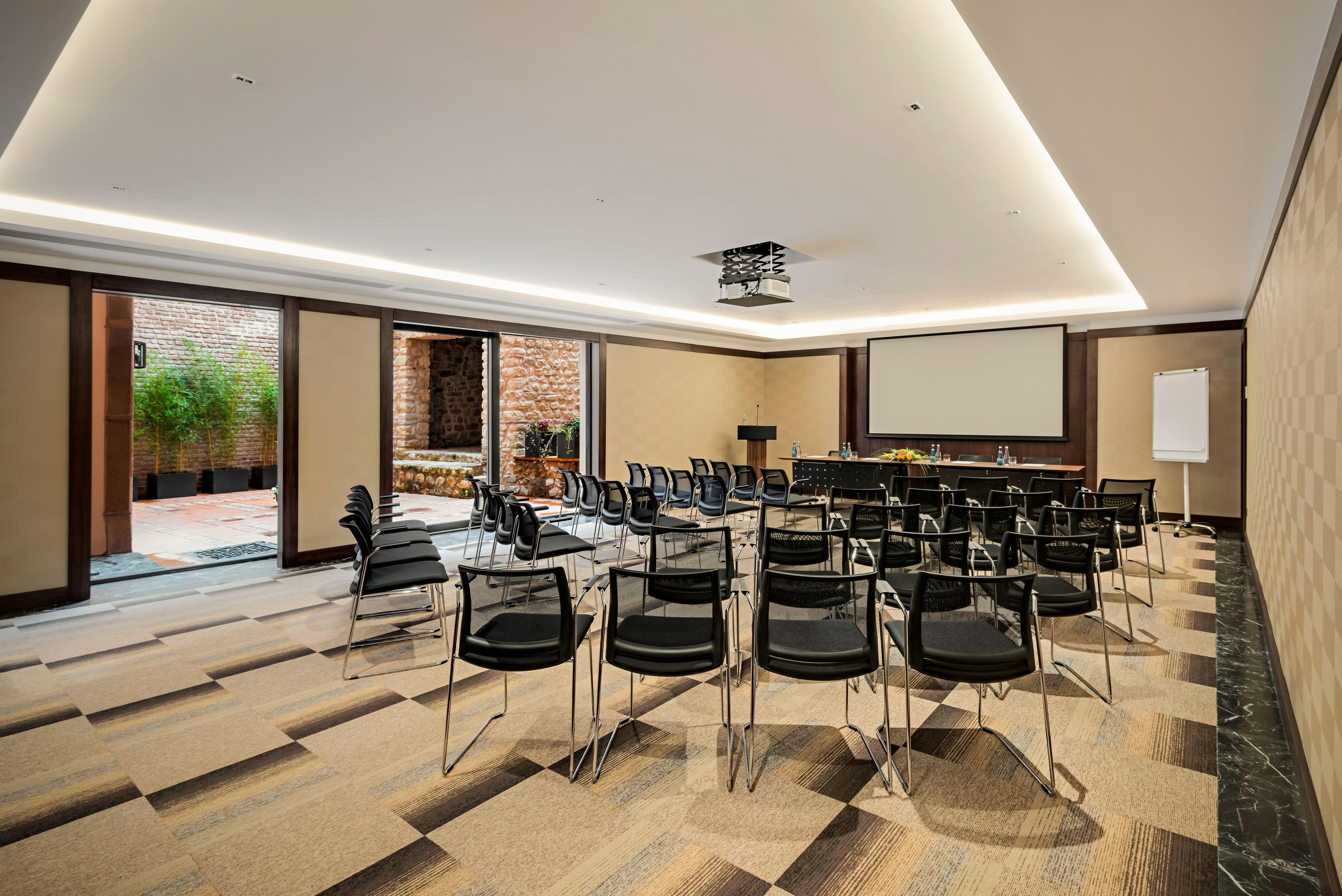 a room with chairs and a screen