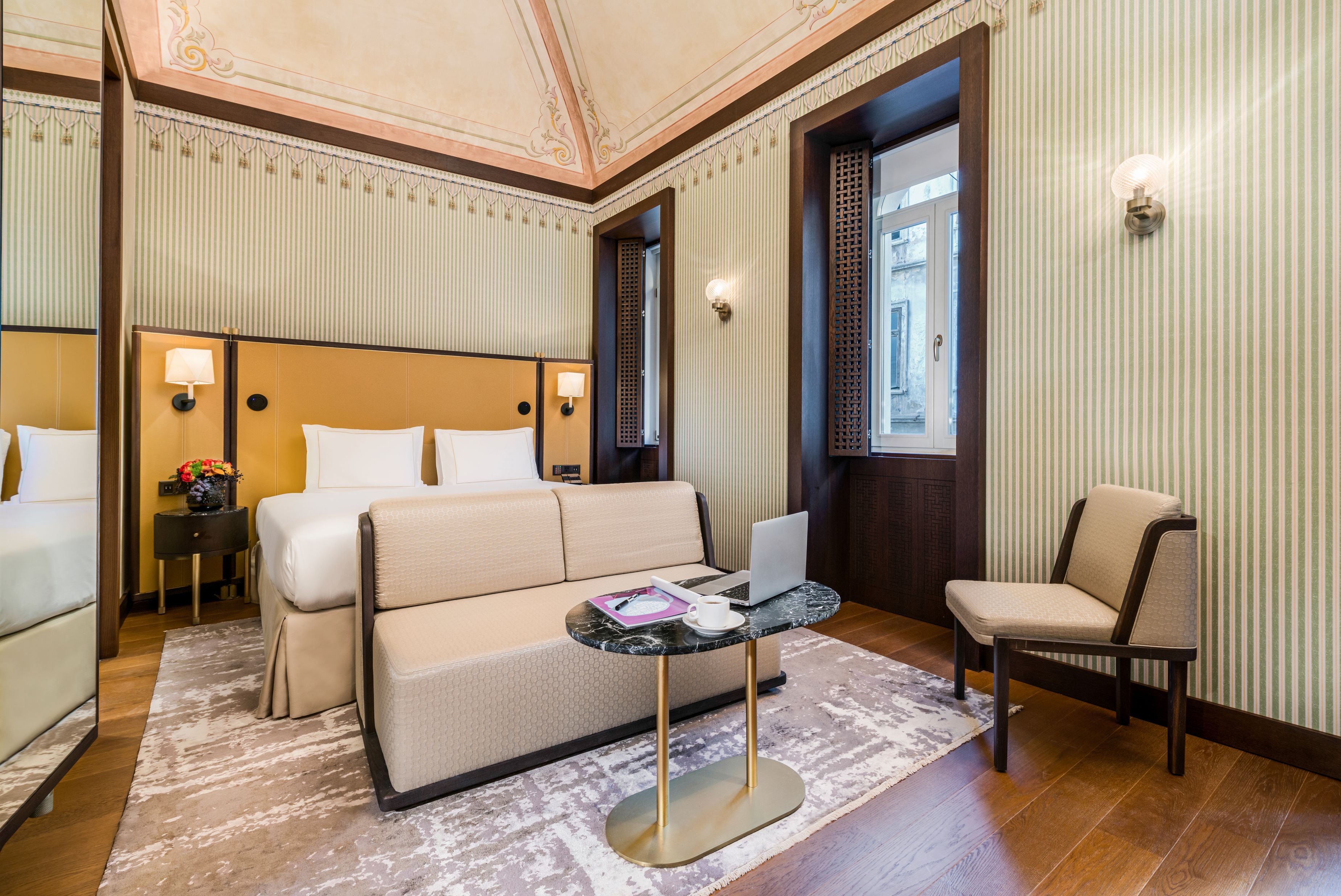 a room with a bed and a laptop
