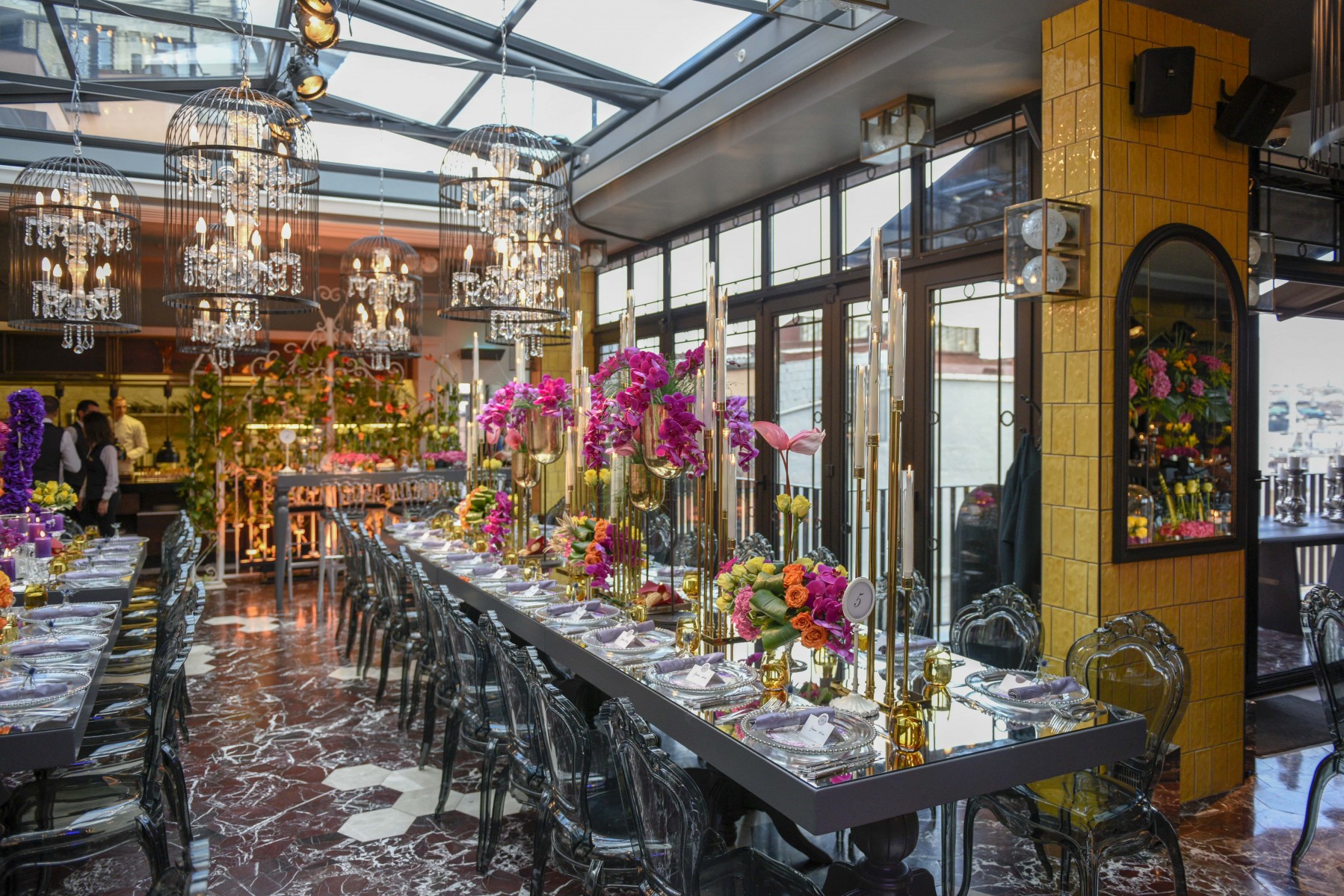 a long table with flowers and candles