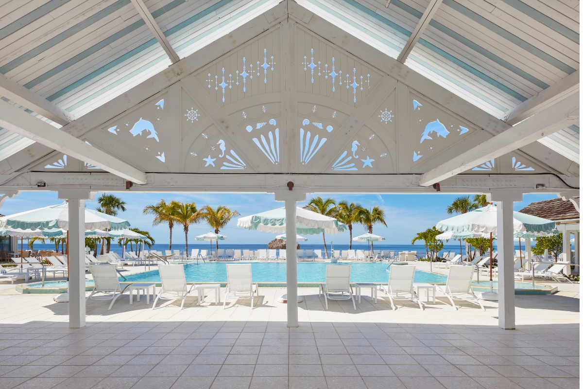 a pool with lounge chairs and umbrellas