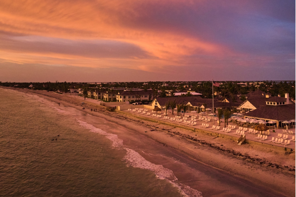 a beach with houses and a body of water