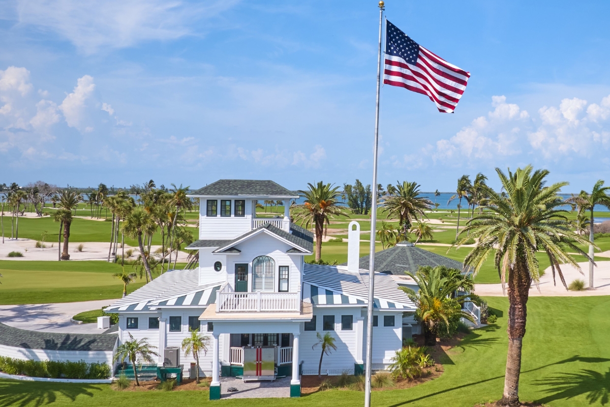 a flag on a flagpole in front of a house