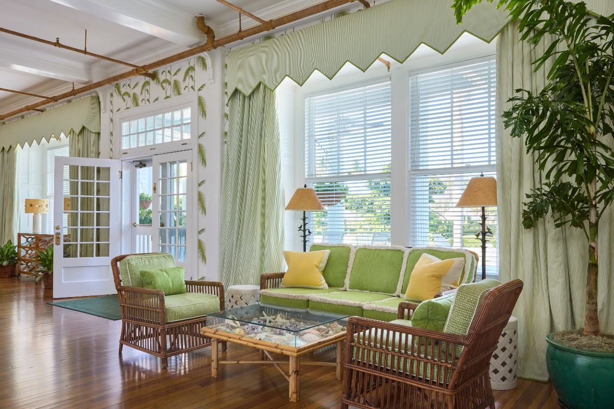 a room with green and white furniture