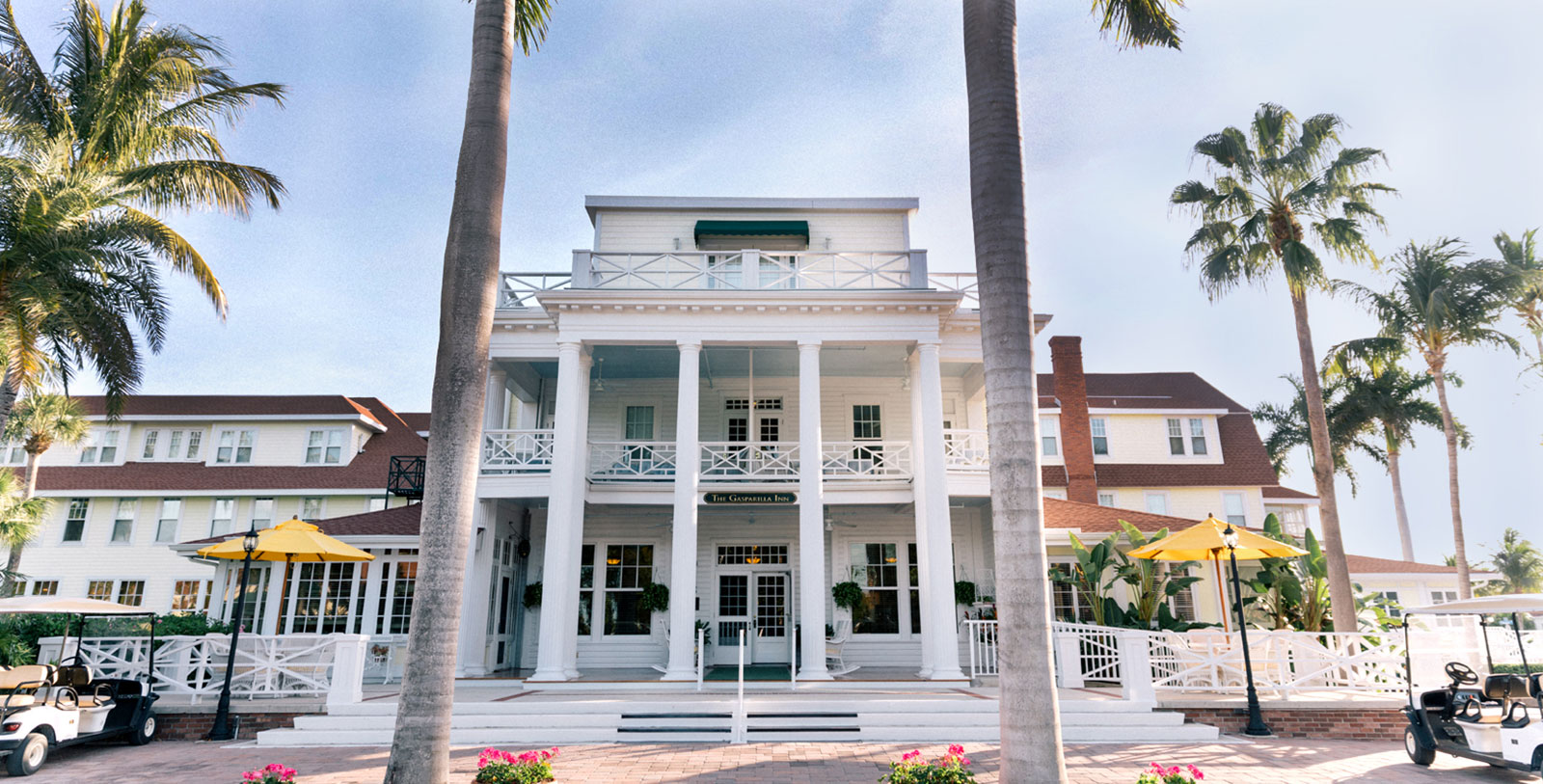 a white building with palm trees