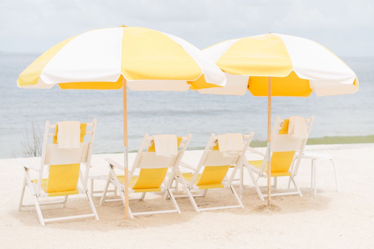 a group of chairs and umbrellas on a beach