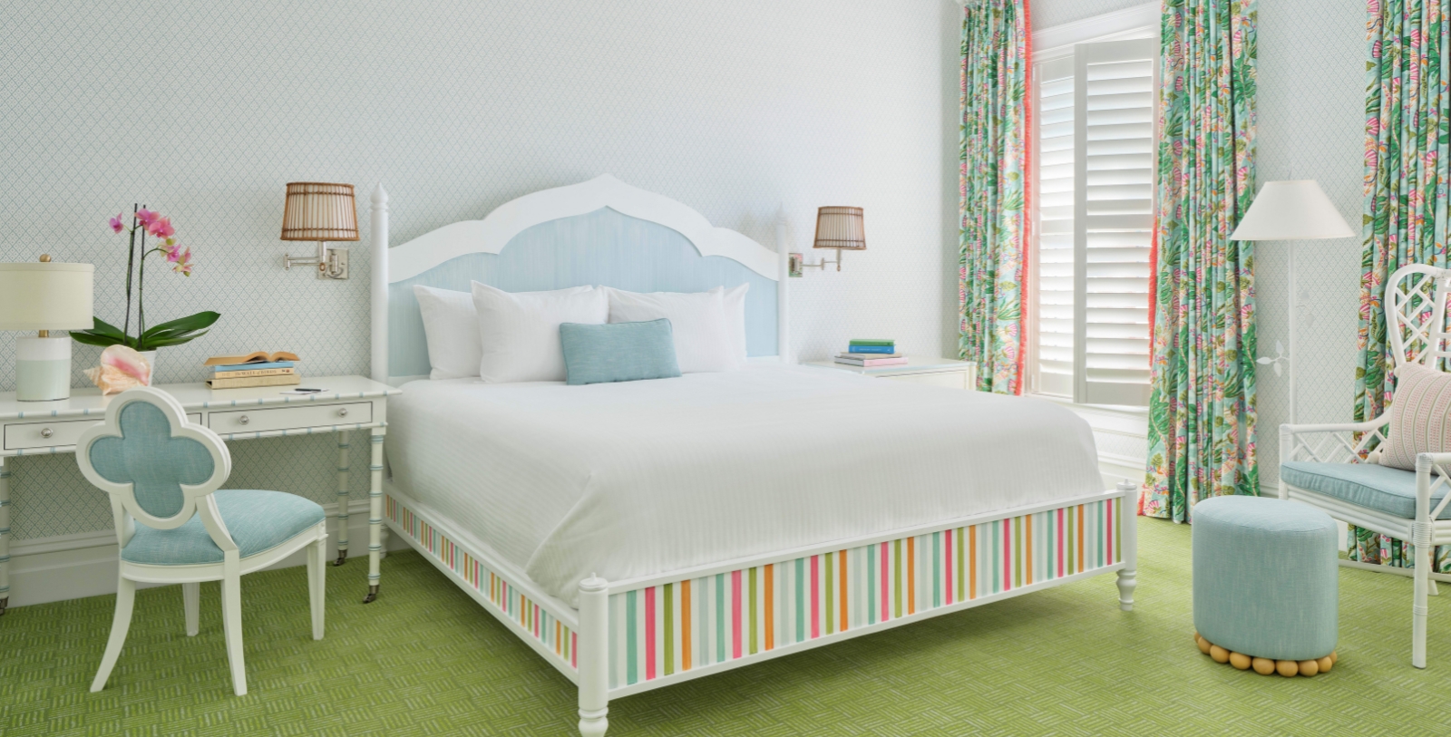 a bed with colorful striped bedding