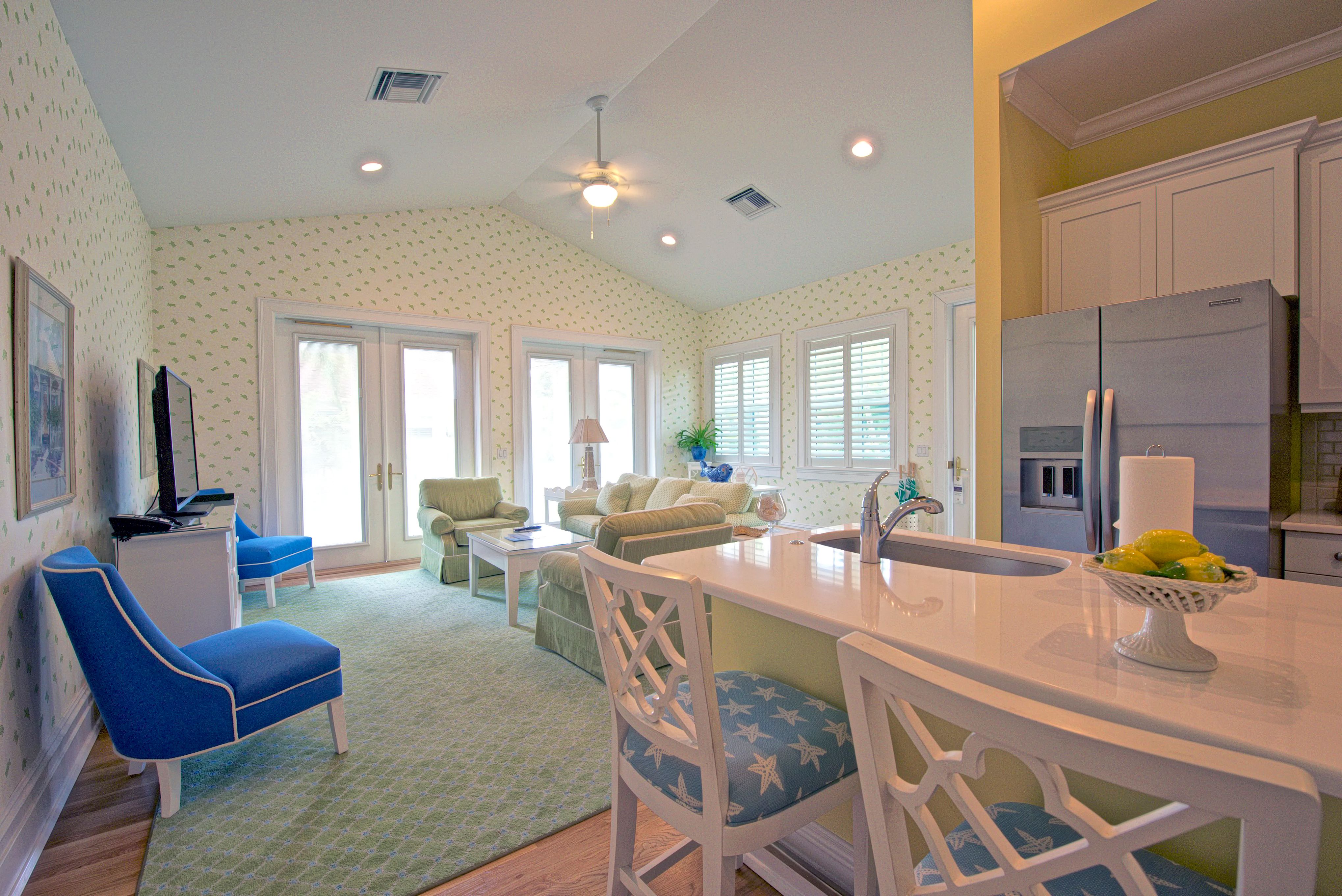 a kitchen and living room with a refrigerator and a refrigerator