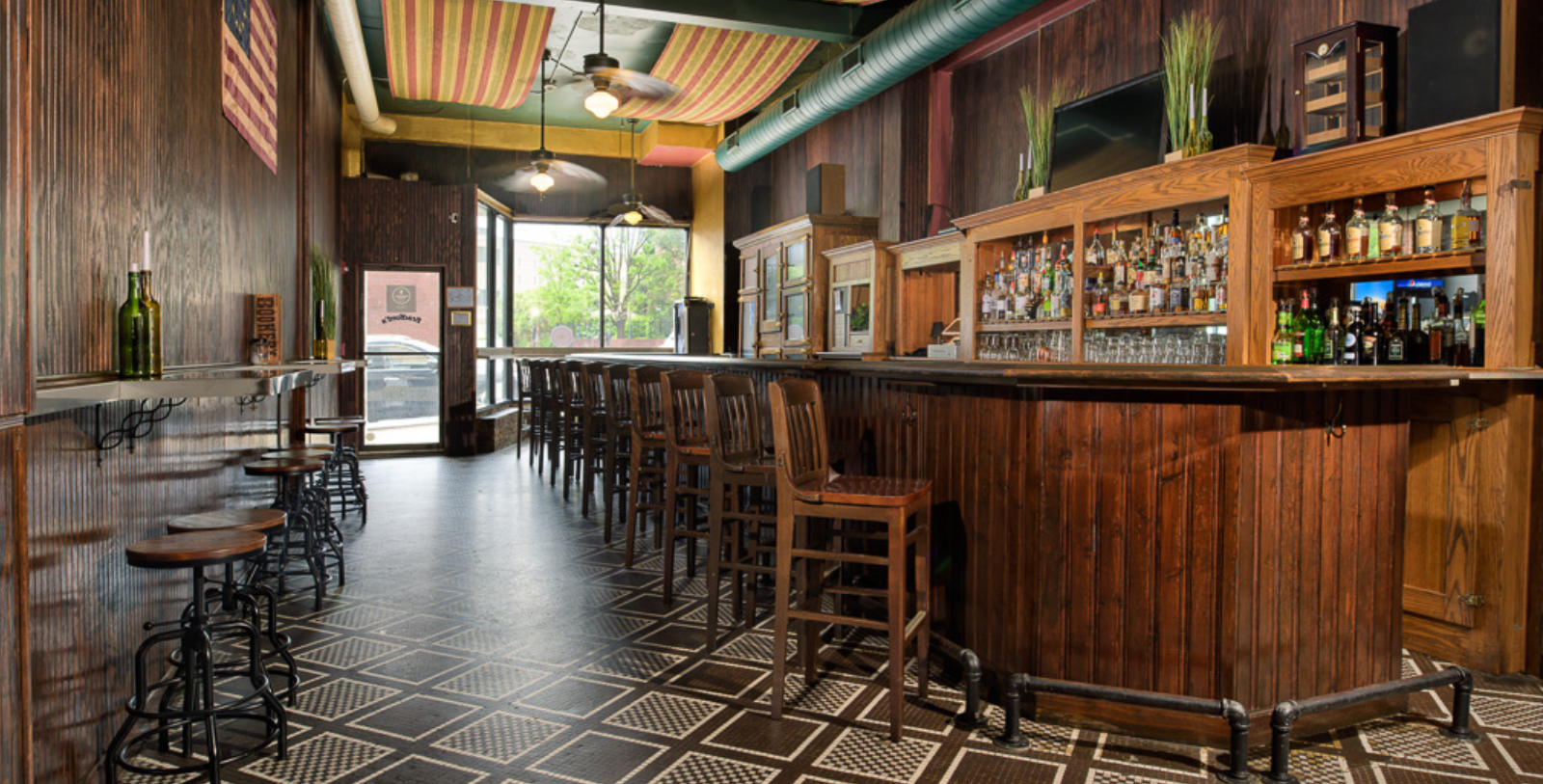 a bar with chairs and a shelf